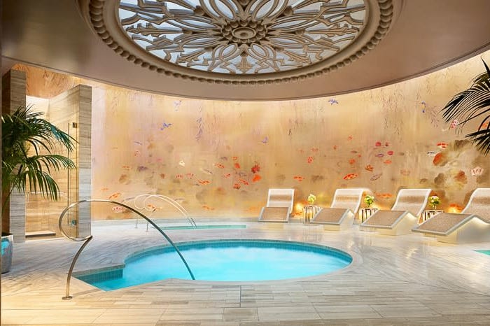 luxury spa area featuring a jacuzzi and relaxation loungers luxury spa area featuring a jacuzzi and relaxation loungers