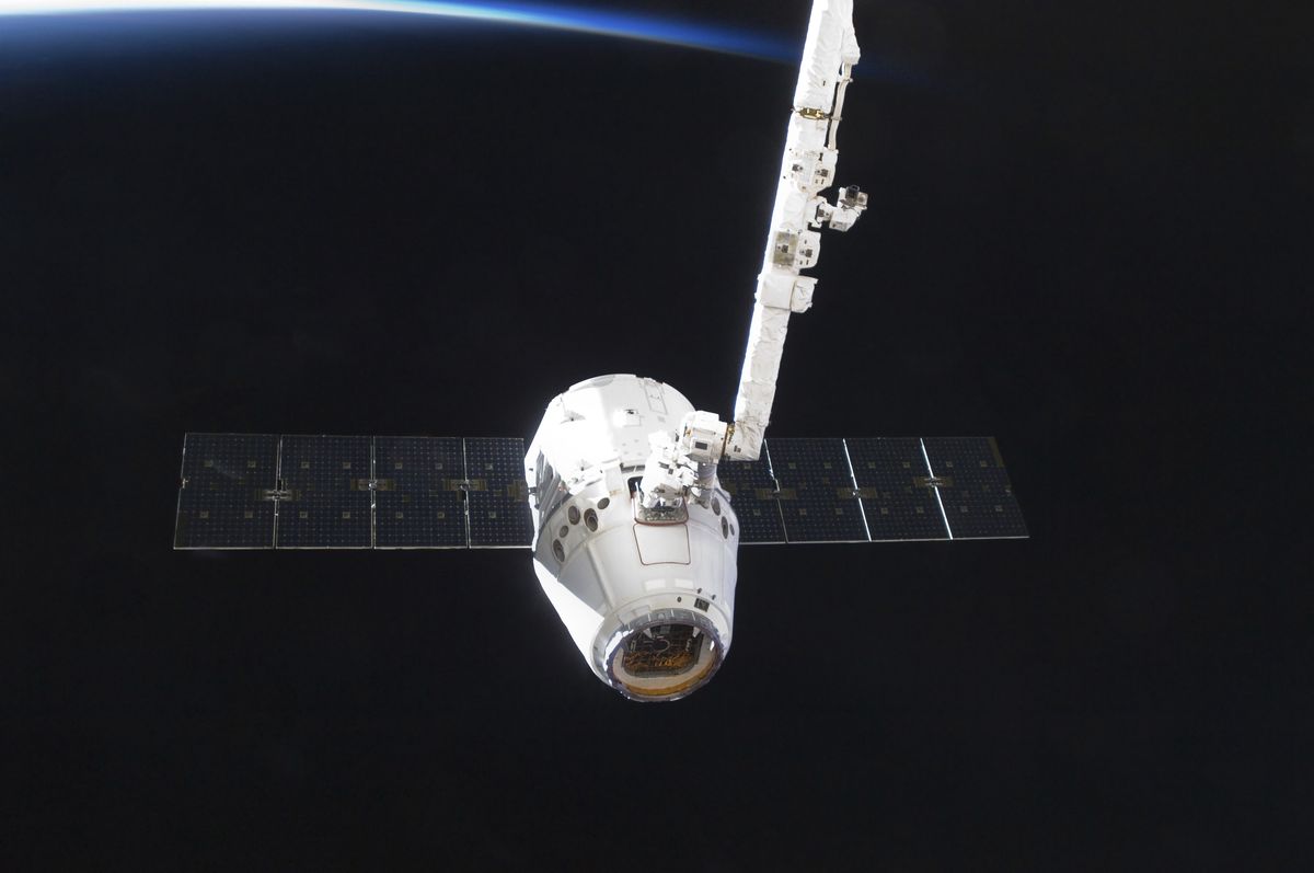 the spacex dragon cargo craft prior to being released from the canadarm2
