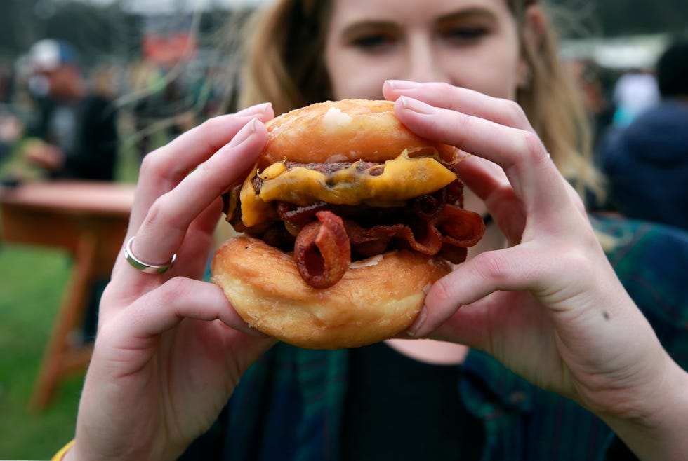 the straw carnival fare in hayes valley in san francisco, is serving up the ringmaster a glazed donut bun cheeseburger during day two of the outside lands music festival in golden gate park in san francisco, california, on sat aug 6, 2016