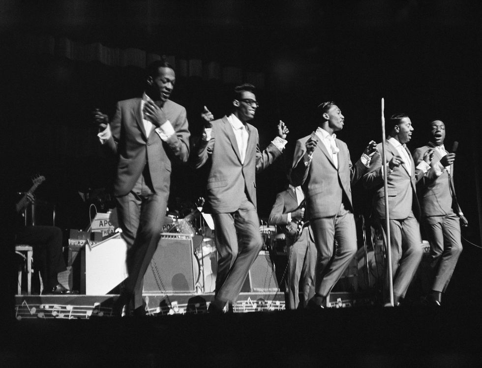 The Temptations perform onstage at the Apollo Theater in 1964 in New York City