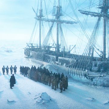 a group of people standing on a ship in the snow