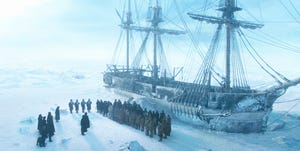 a group of people standing on a ship in the snow