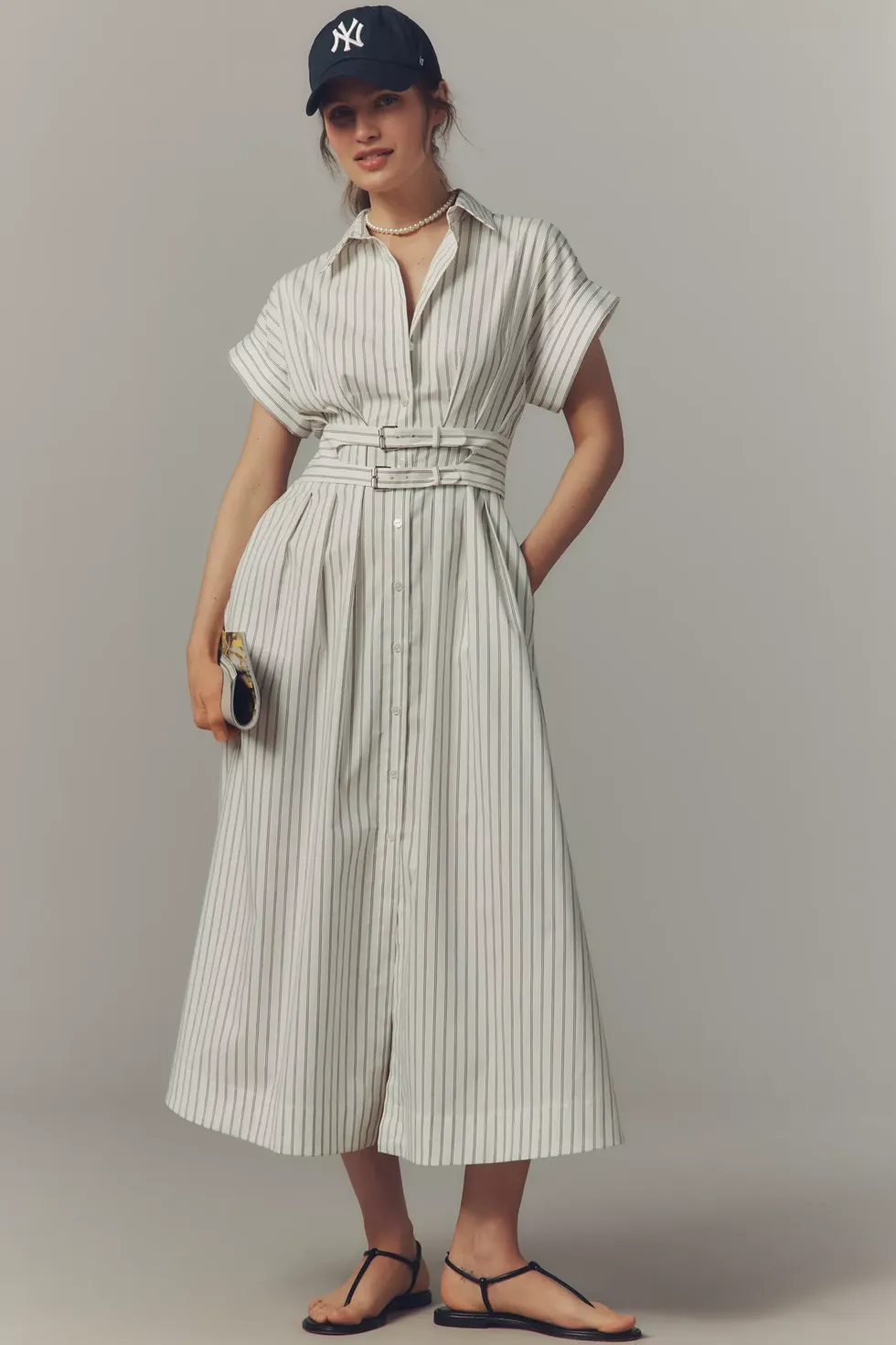 model wearing a striped dress and cap