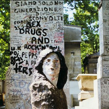 the tomb of jim morrison in paris, france in june, 1985.