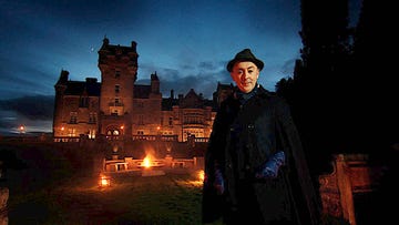 alan cumming outside the traitors castle at night