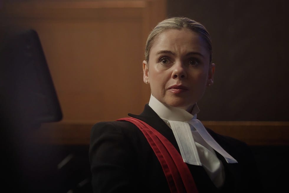 individual in a formal legal attire in a courtroom setting