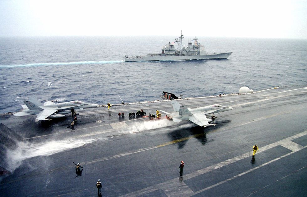 the uss phillipine sea steams off the port side of the uss enterprise