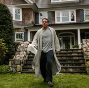 bobby cannavale in the watcher, a man runs out of a house in his pyjamas holding a letter