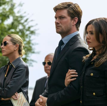 The Waterfront family tree group of people dressed in formal attire standing outdoors likely attending a solemn event