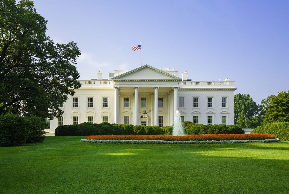 the white house, green lawn, blue sky, early morning light