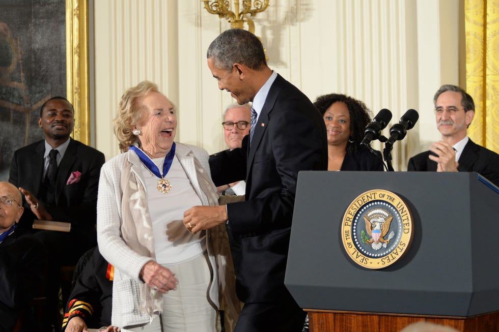 ethel kennedy smiles at barack obama who stands to the right, several people watch from the background