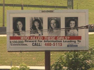billboard seeking information about a crime involving missing girls includes four headshots and text