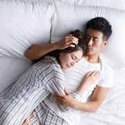 the young couple sleep in bed