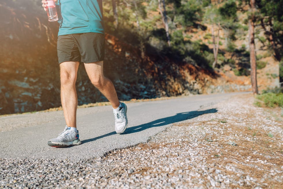 the zen of mountain running a man's spiritual connection to nature unrecognisable man run along a road in mountain area