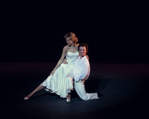 emma corrin as princess diana and jay webb as wayne sleep in the crown season 4