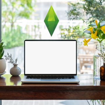 a computer on a desk with the sims green gem indicator floating above it