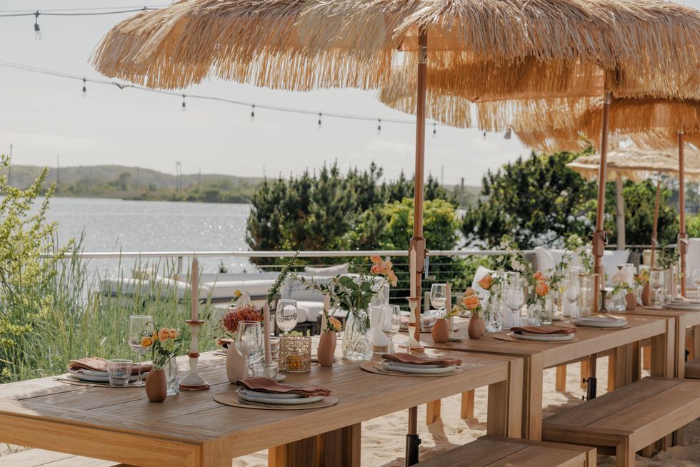 a set table overlooks the ocean at the surf lodge in montauk