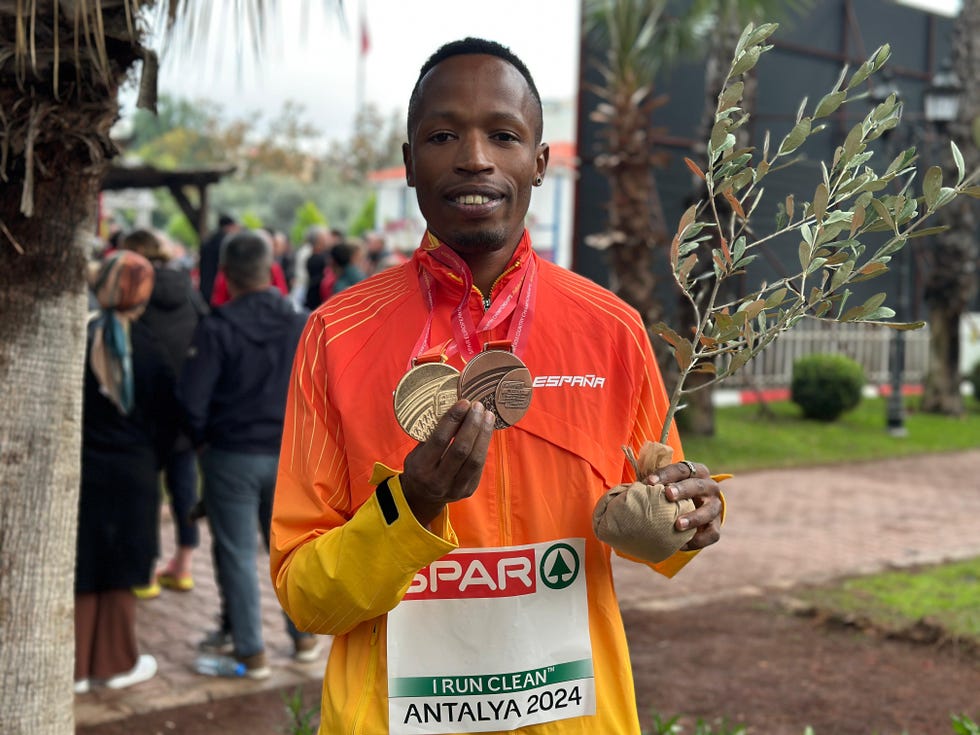 runner celebrating achieved medals and award