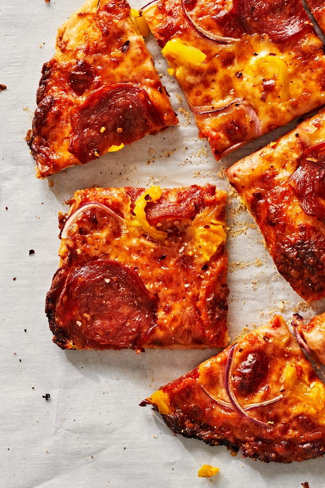 thin crust pizza with pepperoni, onions and banana peppers