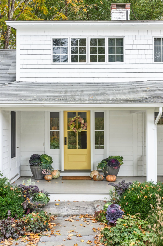 front porch decorated with fall pumpkins