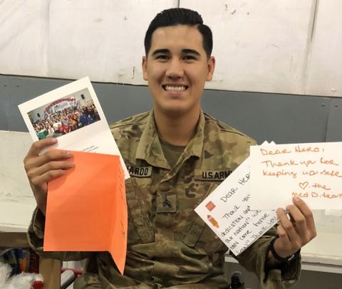 a soldier holding handwritten letters and cards