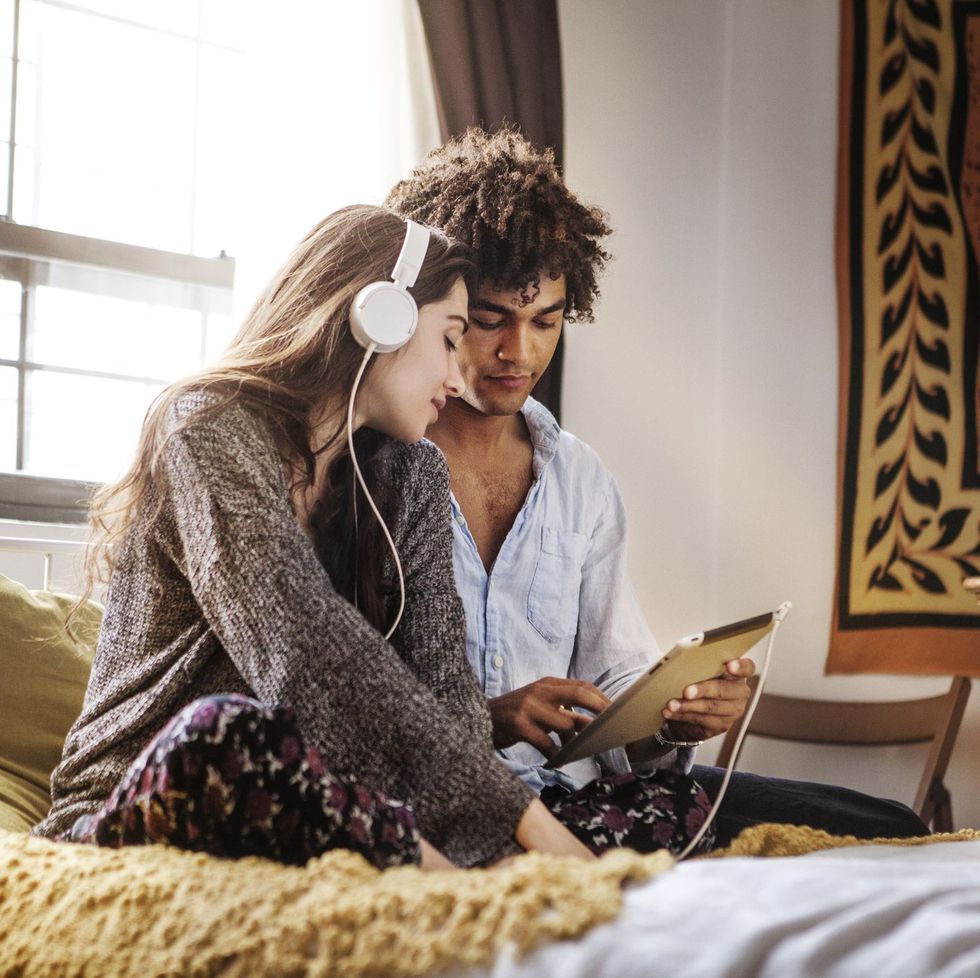 couple listening to music on bed