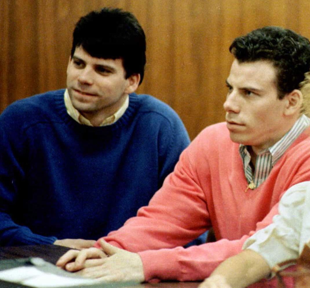 lyle and erik menendez looking toward the judge while sitting at a table