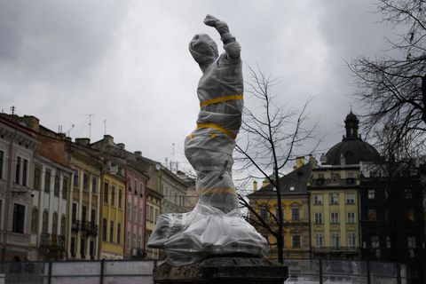 a wrapped statue near the city council in lviv