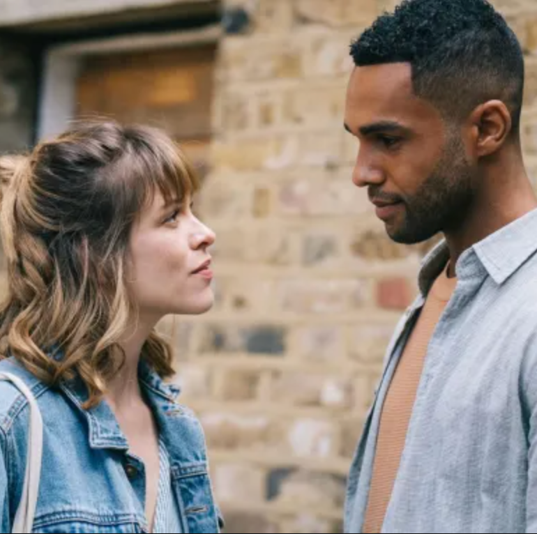 two individuals engaged in conversation against a brick wall two individuals engaged in conversation against a brick wall