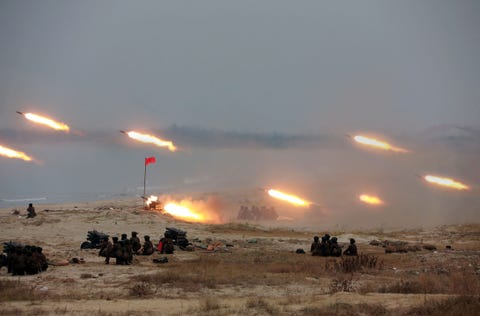 North Korean multiple rocket launchers firing during a women's rocket crew firing contest, date unknown