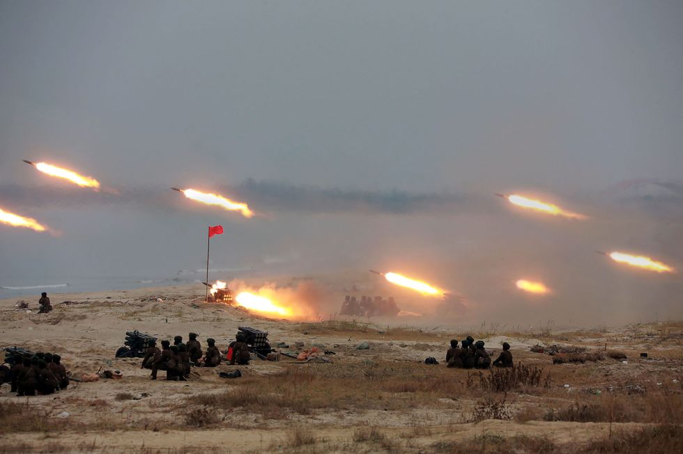 north korean multiple rocket launchers firing during a women’s rocket crew firing contest, date unknown