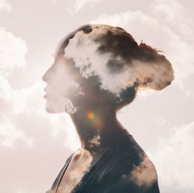 clouds and sun over the shadowed silhouette of a female head
