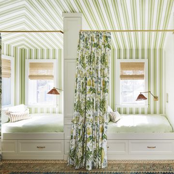 tented stripes transform a space over the garage into cabana style guest quarters