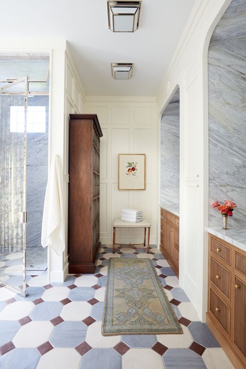 graphic flooring tile in the primary bath marries limestone with gray and mahogany marble