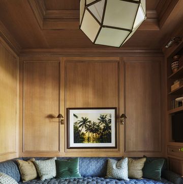 a tufted indigo sectional  turns the study into a corner hideaway