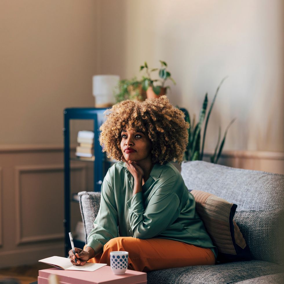 woman writing in notebook at home