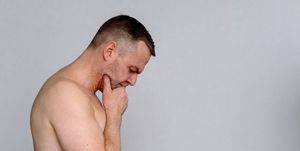Thoughtful shirtless middle-aged man