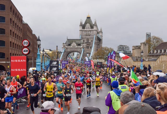 thousands of runners pass across tower bridge during london