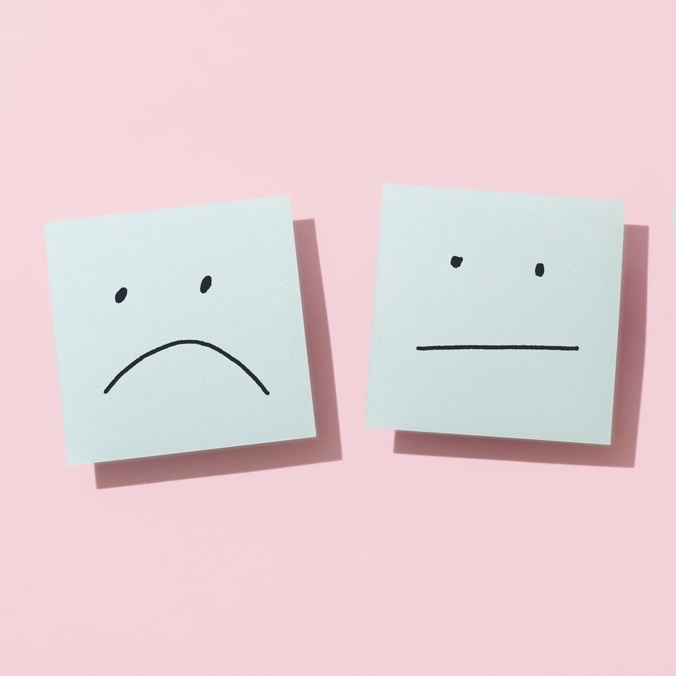 three blue sticky blank notes on pink background
