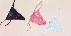 three differents colors of string lace panties isolated on pink background