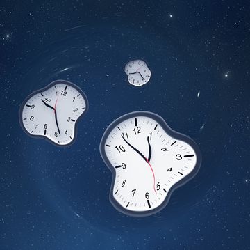 three clocks that are warped against a starry blue background