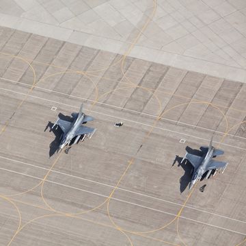 three f 16 fighter jets on tarmac ready for flight