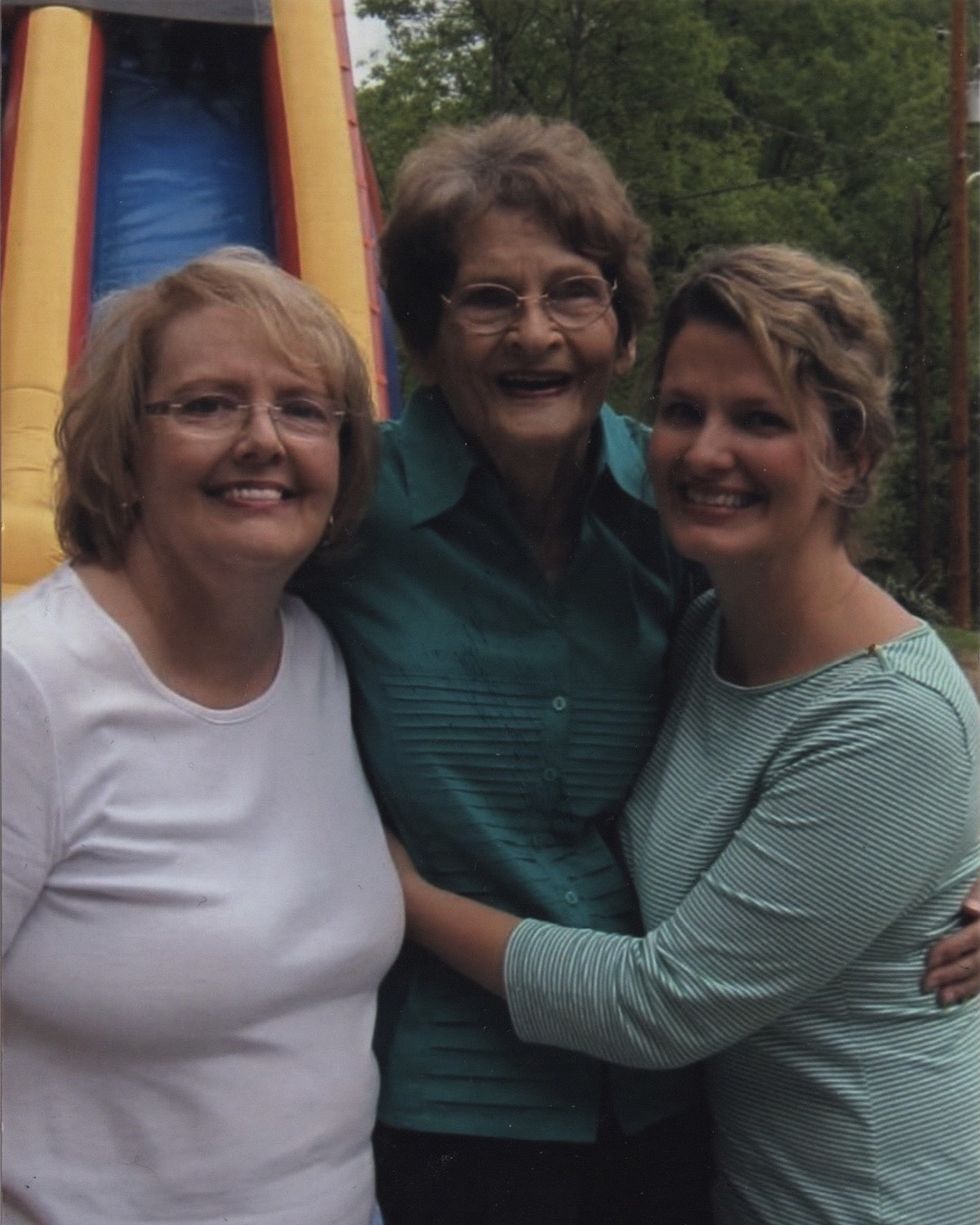 kin author shawna kay rodenberg pictured with her mom and grandmother in front of a bounce castle