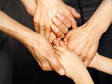 three generatios of women holding hands