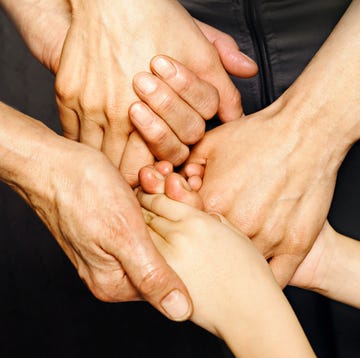 three generatios of women holding hands