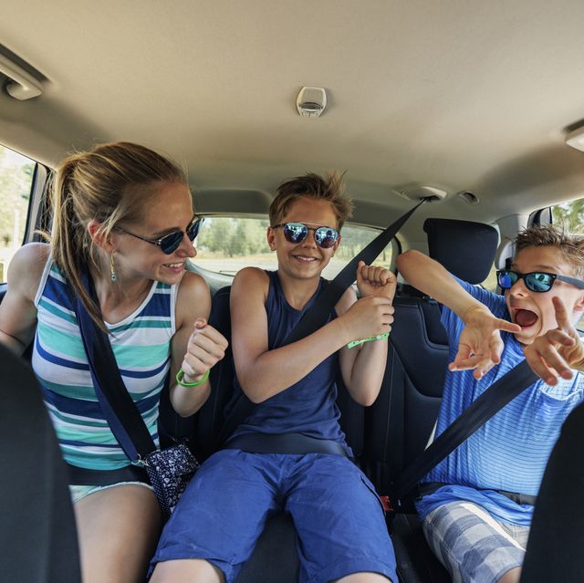 three kids travelling by car