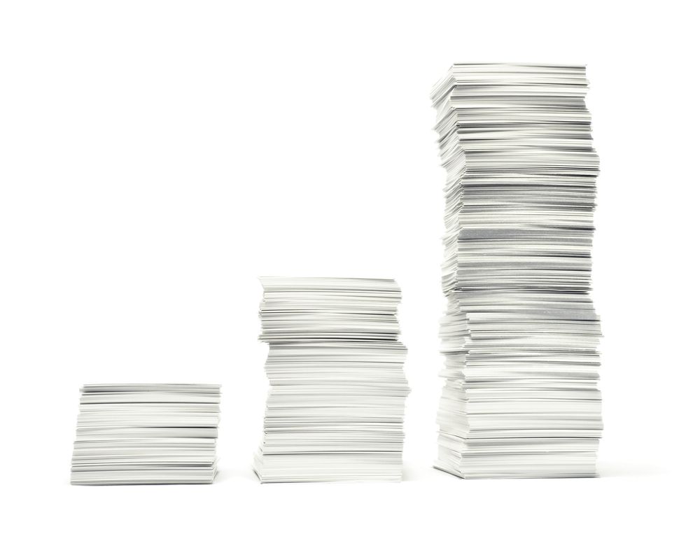 Three stacks of paperwork on white background