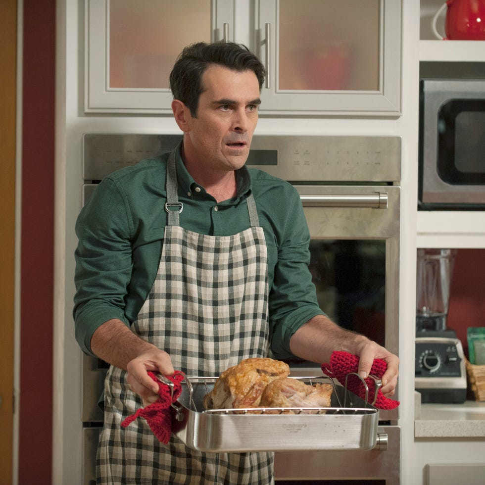 modern family star phil holding a turkey