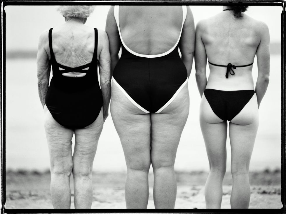 Three women of various age and size in swimwear, rear view (B&W)