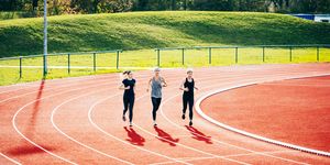 three women running long distance on outdoor track